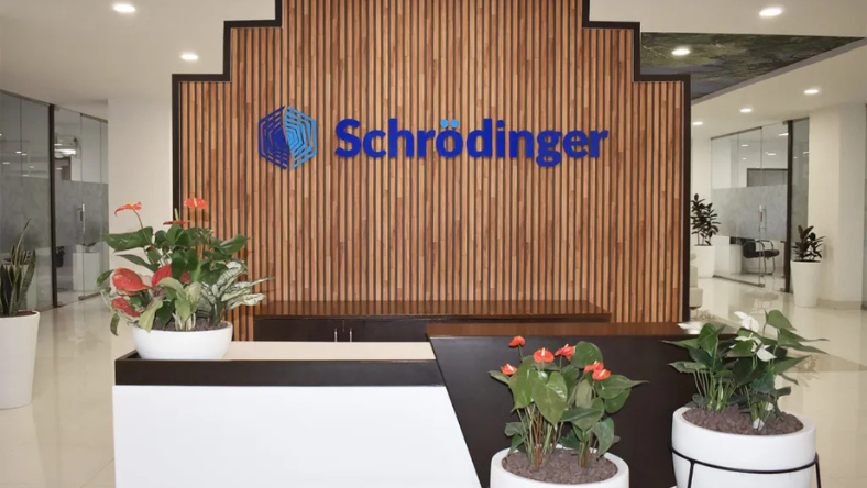 Schrödinger logo on a wooden feature wall inside an office lobby